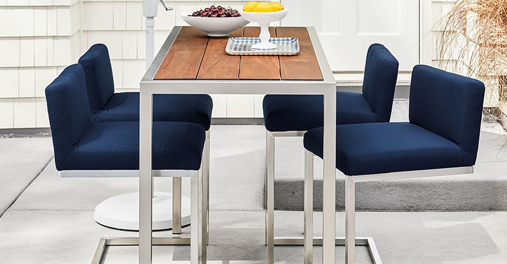 Montego outdoor counter table and Finn counter stools on a patio