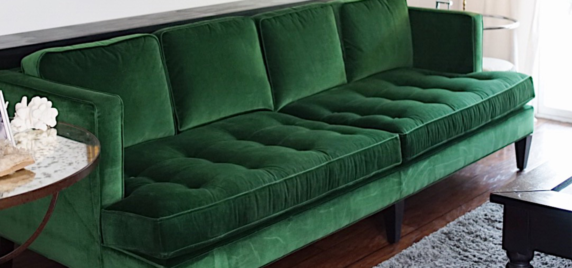 Green velvet sofa in living room