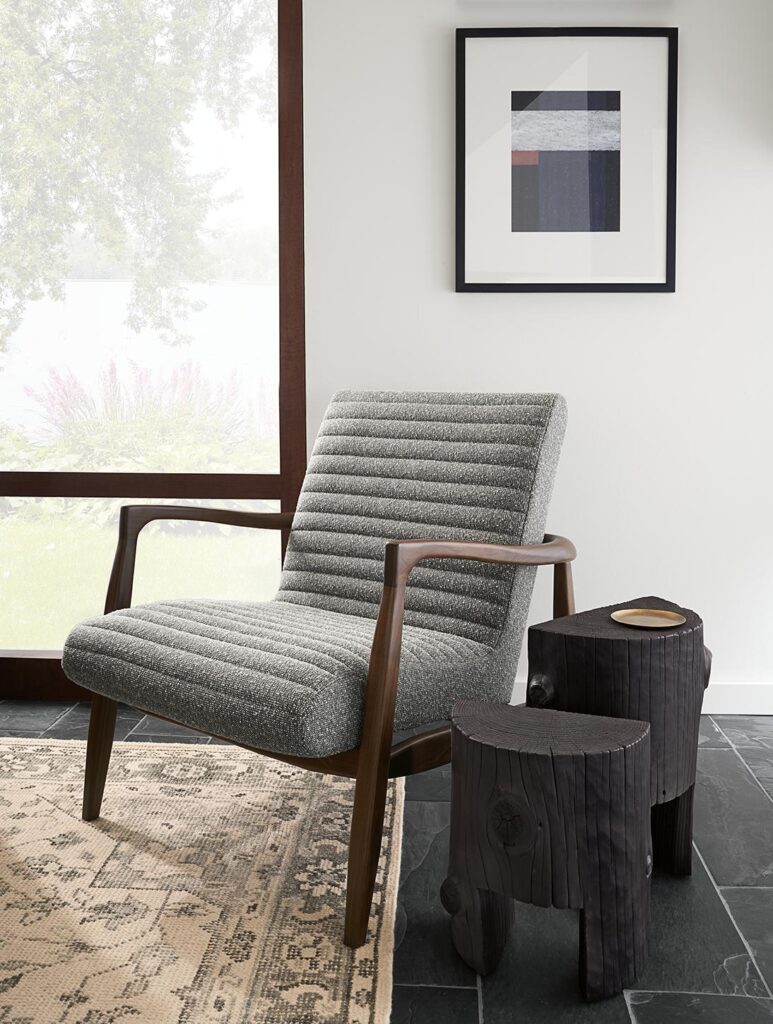Callan accent chair in walnut and gray fabric beside two Casetta end tables.