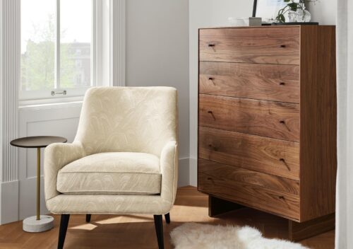 Detail image of Quinn accent chair in white fabric and Hudson dresser in walnut.