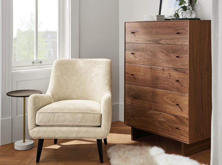 Detail image of Quinn accent chair in white fabric and Hudson dresser in walnut.