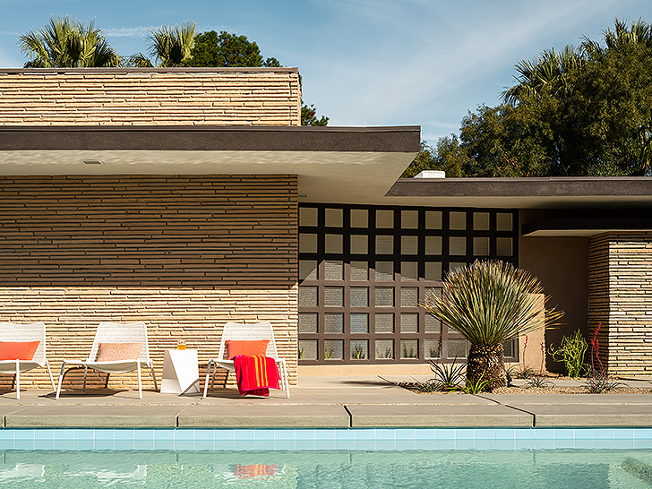 Outdoor lounge chairs lined up by the pool