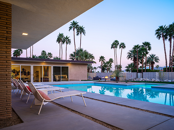 Outdoor space overlooking sunset with palm trees
