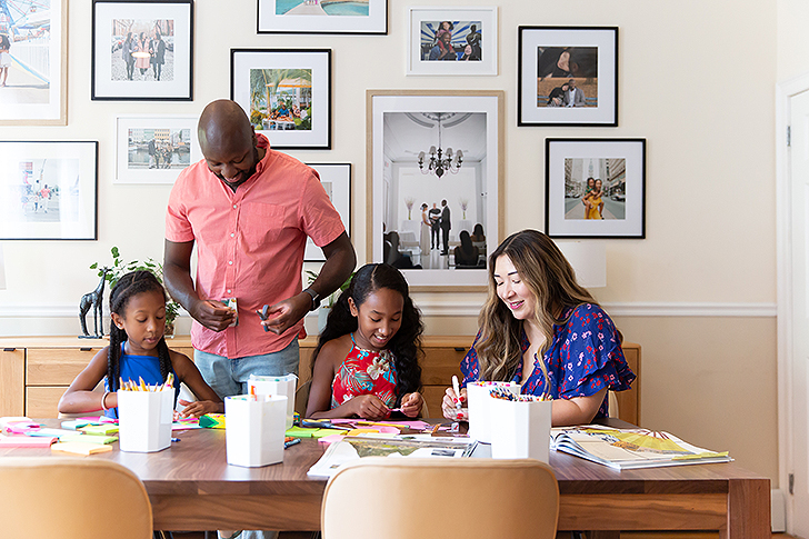 family of four doing crafts at dining table