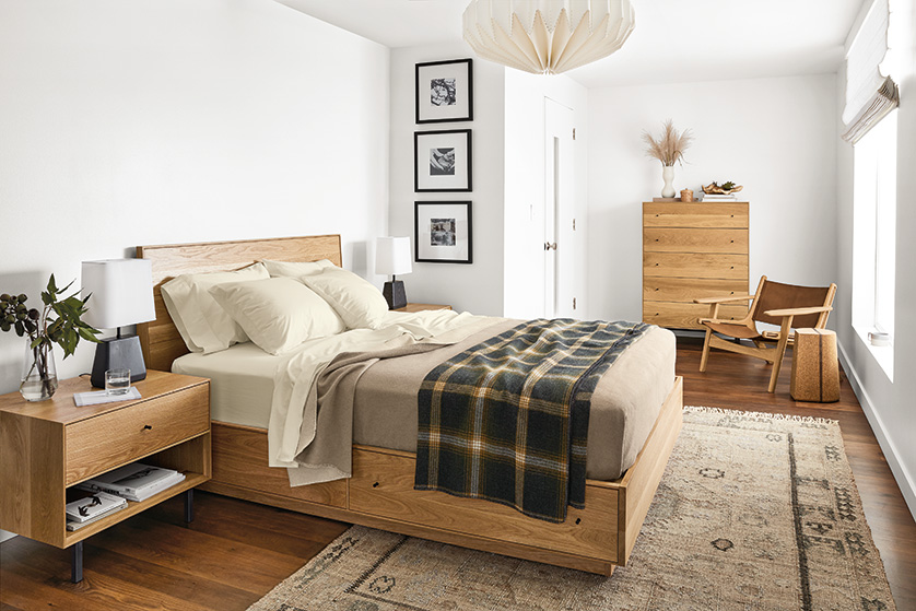 Hudson queen bed, dresser and nightstand in white oak. Lars chair near a window.