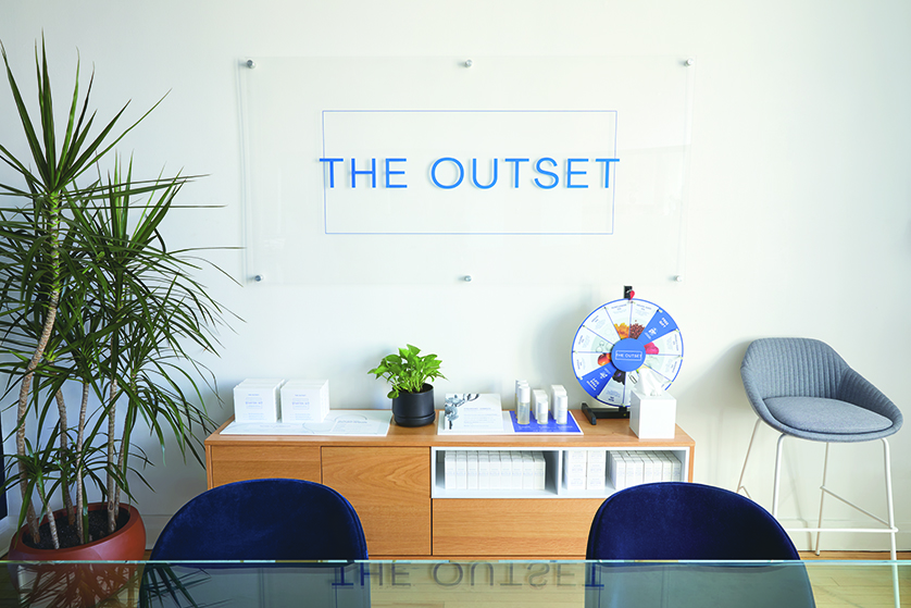 The Outset company sign behind their front desk.