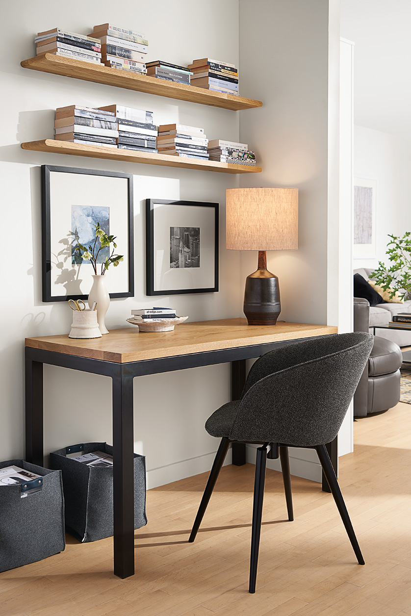 Small space home office with Parsons desk, Sylvan swivel chair, Meridien table lamp, Eris shelves and Profile frames.