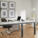 Office area with Parsons Adjustable height standing desk in graphite and light grey quartz top in seated position with Cora office chair.