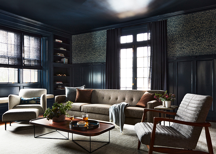 Moody navy living room in a historic Concord home. Features original millwork.