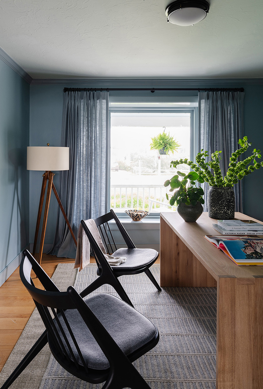 Home office featuring solid wood desk and spindle chairs.