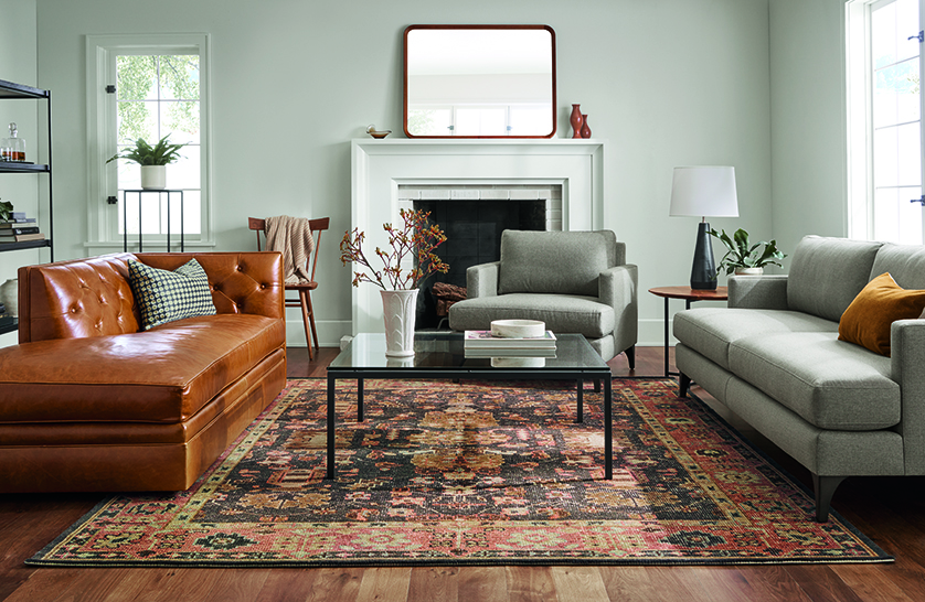 Living room with carlton sofa and chair in gino coal, macalester chaise in vento cognac leather, tillia rug in brick.