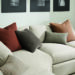 detail of custom throw pillows on white sofa.