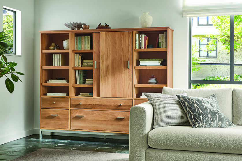 Living room with detail of linear custom 78-wide twelve insert cabinet in white oak with sliding door open.