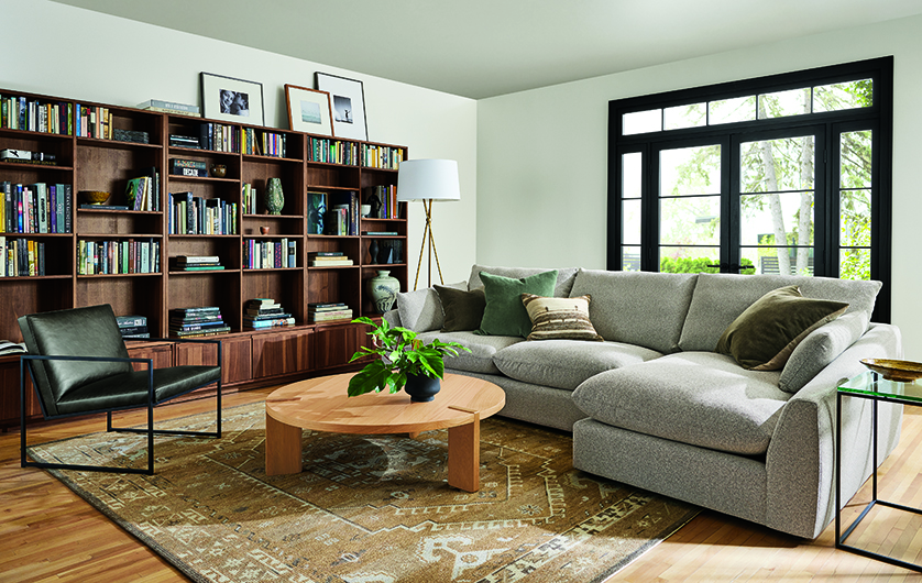 Living room with Weber sofa in Tatum Bone and Navato chair in Palermo charcoal leather.