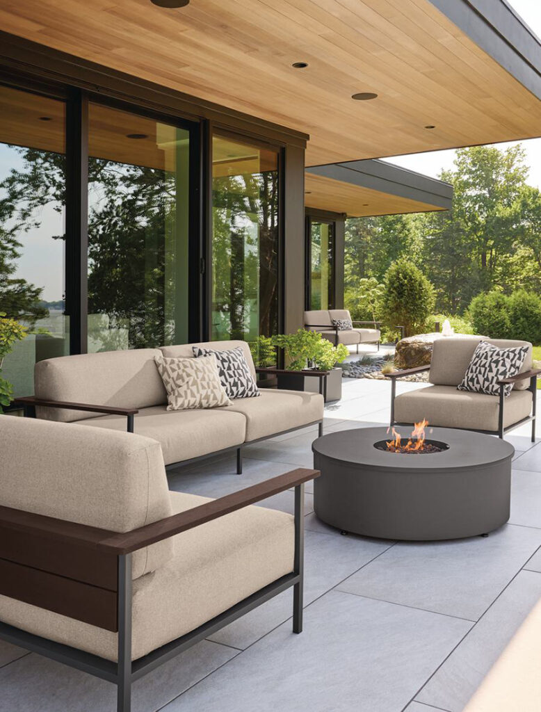 Marin outdoor sofa and chairs with Adara fire table on stone patio.