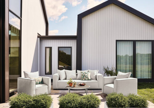 Oasis sofa and chairs in front of modern farmhouse.